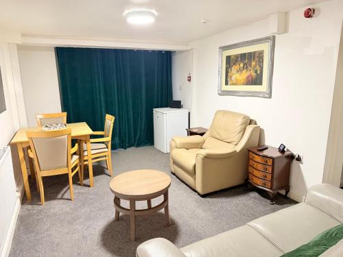 a living room with a couch and a table at 1 Luxe Bed Apt GView Derby City in Derby