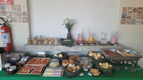 a table with many different types of food on it at Pousada Flor do Campo in Serra do Cipo
