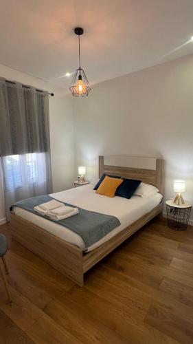 a bedroom with a large bed and two lamps at Amazing Blue House in Ribeira Grande