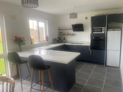 a kitchen with blue cabinets and a white refrigerator at 12A Benbulben View in Bundoran