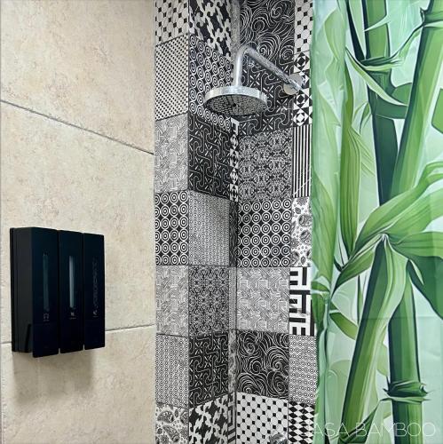 a bathroom with a black and white tiled wall at Casa Bamboo in Mexico City