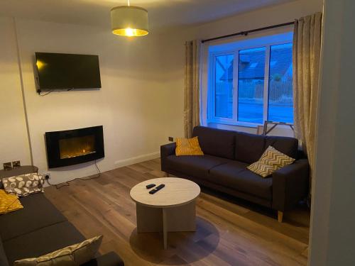 a living room with a couch and a fireplace at 12A Benbulben View in Bundoran