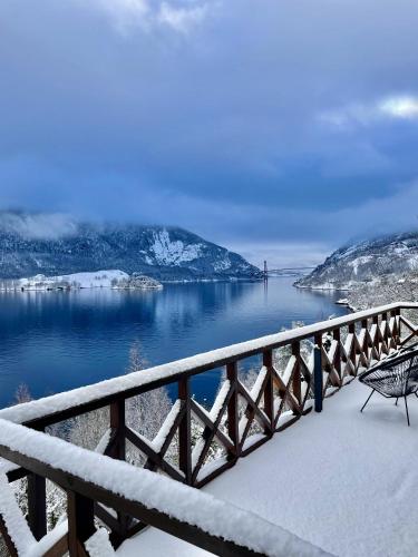 a balcony with a view of a body of water at FjordCabin Preikestolen in Strand