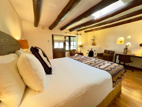 a bedroom with a large white bed in a room at Old Taos Guesthouse B&B in Taos