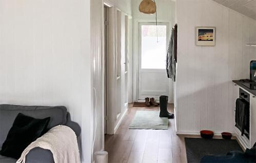 a living room with a couch and a window at 2 Bedroom Nice Home In Hundested in Hundested