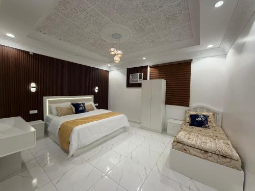 a bedroom with a bed and a desk and a sink at شقق النبلاء in Medina