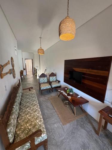 a living room with a couch and a table at Casa Aura Solis Preá in Prea