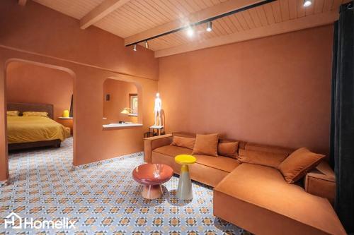 a living room with a couch and a bed at Santa Clara - the revolution of living in Chalkida