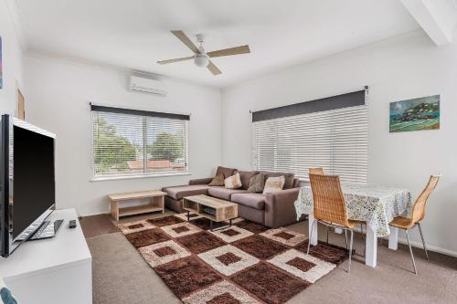 a living room with a couch and a table at H2O Holiday Apartments Unit 5 in North Haven
