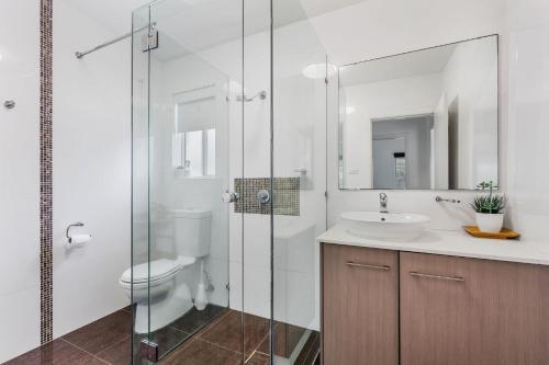a bathroom with a toilet and a sink and a shower at H2O Holiday Apartments Unit 5 in North Haven