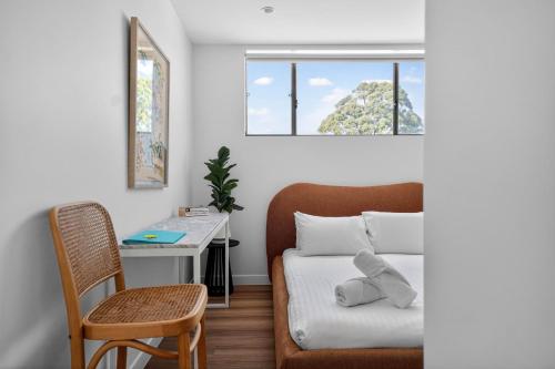 a bedroom with a bed and a desk and a window at Bonanza Lane Hideaway in Sydney