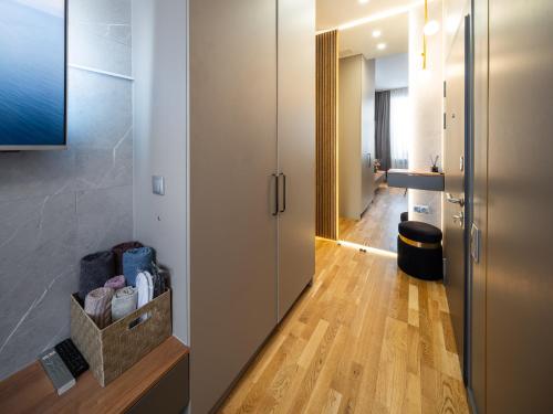 a hallway with a door to a room with wood floors at Premium Design, Renovated 2024 Free parking in Riga