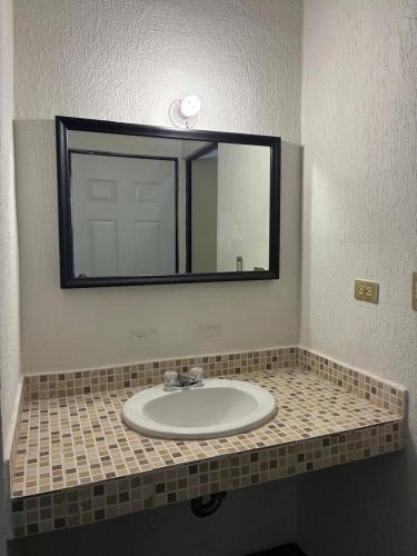a bathroom with a sink and a mirror at Modern 2-Bedroom House in Guaymas in Guaymas