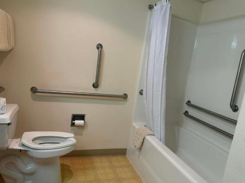 a bathroom with a white toilet and a shower at Aspen Lodge in Croftville