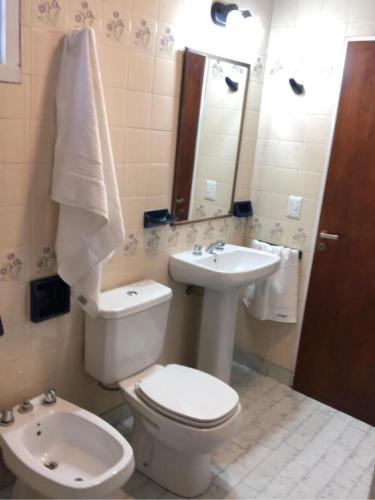 a bathroom with a toilet and a sink at House beach in Puerto Madryn