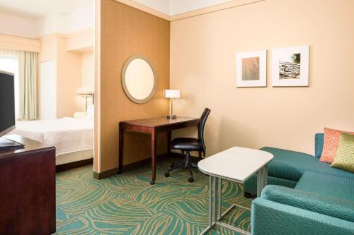 a hotel room with a bed and a desk and a couch at SpringHill Suites by Marriott Cheyenne in Cheyenne
