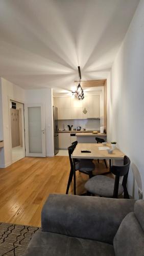 a living room with a table and a couch at CL Home Lux in Podgorica