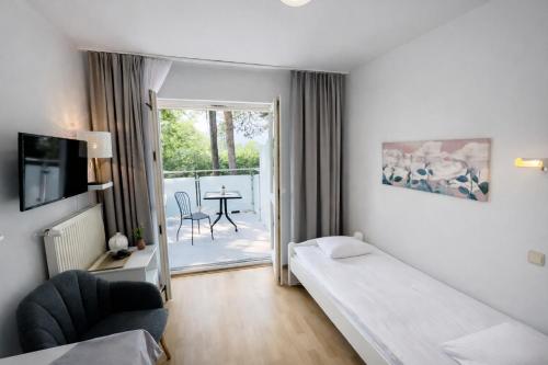 a hotel room with a bed and a balcony at Ośrodek TVP in Ciechocinek