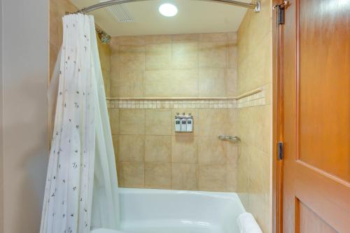 a bathroom with a shower and a white tub at Olympic Valley Summer Sanctuary in Everline Resort in Olympic Valley