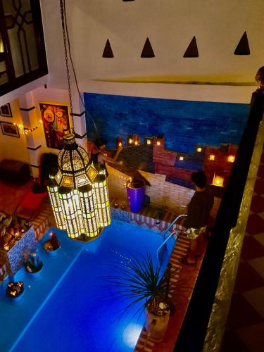 a room with a table with a view of the ocean at sharing is caring in Tamraght Ouzdar