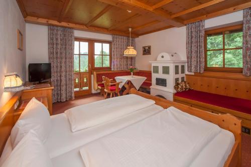 a bedroom with a large white bed in a room at Hotel Gut Kramerhof in Kirchdorf in Tirol