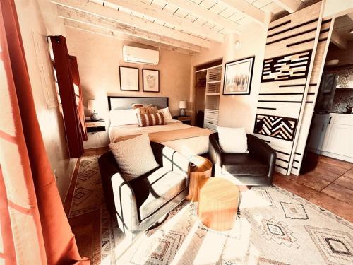 a bedroom with a bed and a couch and a table at Serenity in Santa Fe