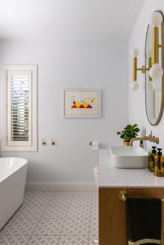 a white bathroom with a tub and a sink at St Agnes by Prunella in Kyneton