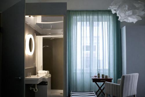a bathroom with a sink and a mirror and a window at Maison Geraldine in Marcianise