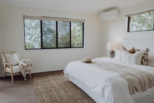 a white bedroom with a large bed and a window at Acreage property, pet friendly, outdoor campfire in Bald Knob