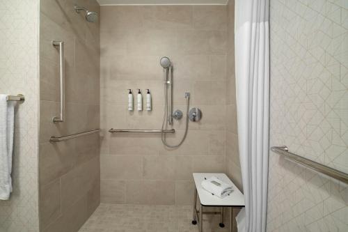 a bathroom with a shower and a sink at SpringHill Suites Boca Raton in Boca Raton