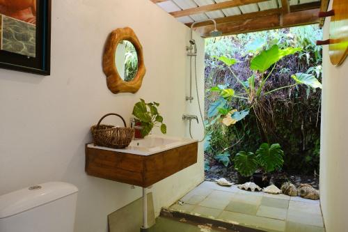 een badkamer met een wastafel naast een raam bij Enjoy Camanukea Lodge in Mahina