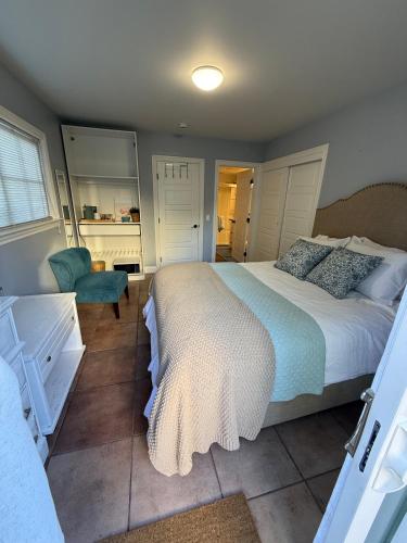 a bedroom with a large bed and a chair at Eastside Costa Mesa Residence in Costa Mesa