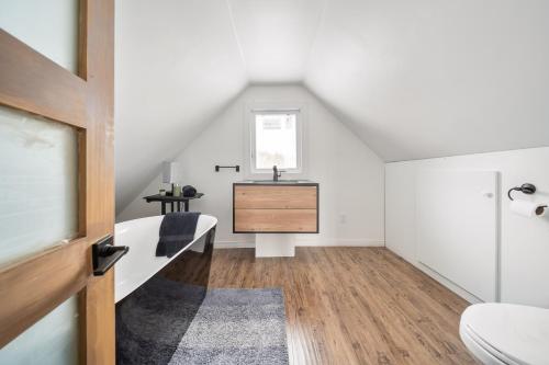 a attic bedroom with a bed and a sink at Évadez-vous à Grandes-Piles in Grandes-Piles