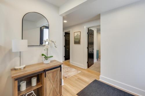 a hallway with a mirror and a table with a lamp at Beach Access & Fire Pit! Potomac River Retreat in Montross