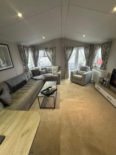 a living room with a couch and a table at Luna Retreat - Newbiggin by the Sea in Newbiggin-by-the-Sea