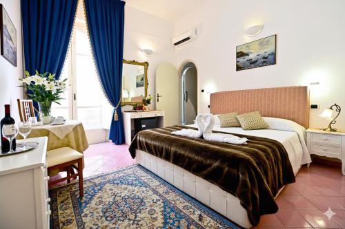 a hotel room with a bed and a table at Residenza Sole Amalfi in Amalfi