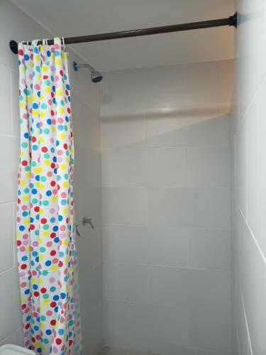 a shower curtain with polka dots on it in a bathroom at Hostal Tayupanda in Quito