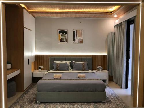 a bedroom with a large bed and two white tables at Light Star Villa in Kuta Lombok