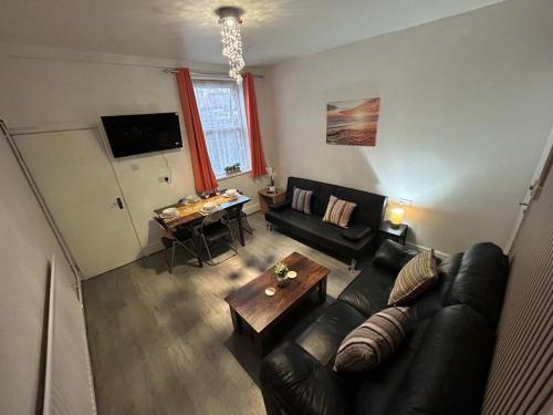 a living room with a couch and a table at West Bromwich Apartment for 2 guests in West Bromwich