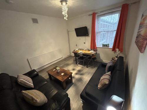 a living room with a couch and a table at West Bromwich Apartment for 2 guests in West Bromwich