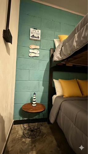 a room with a bed and a table next to a bed at Cabaña la Industrial in Coveñas