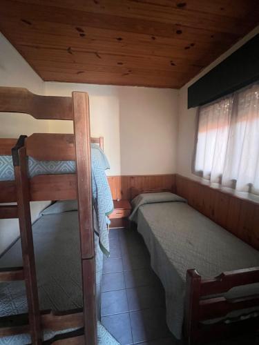 a bedroom with two bunk beds in a cabin at Azahares in Termas del Daymán