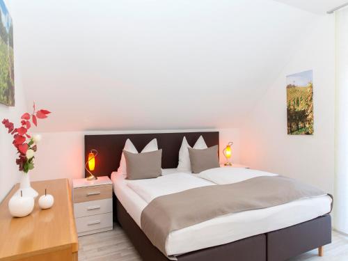 ドイチュランツベルクにあるFerienhaus Kleindienstのベッドルーム1室(大型ベッド1台、ランプ2つ付)