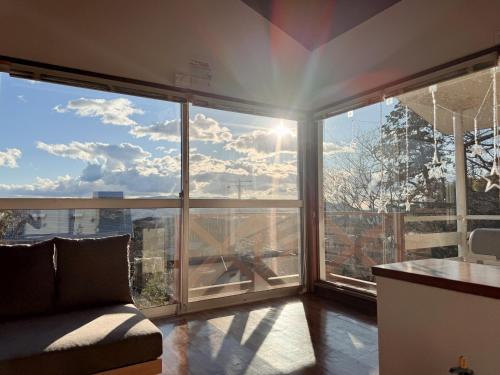 a living room with a large window with a view at 羽咲亭乃台 in Kannami