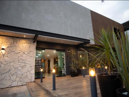a lobby of a building with potted plants and candles at Hotel Ix By San Clemente in Tlaxcala de Xicohténcatl