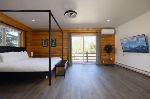 a bedroom with a bed in a room with wooden walls at Sisters Cabin in Sisters