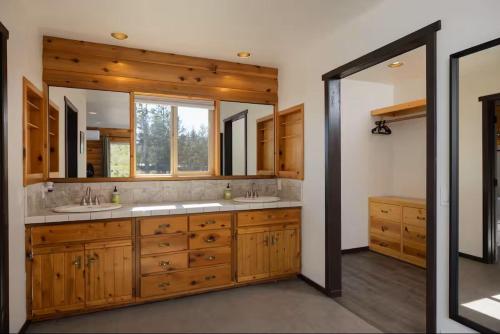 a bathroom with two sinks and two mirrors at Sisters Cabin in Sisters