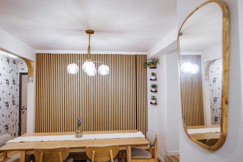 a dining room with a table and a mirror at SunStar Alaska Bed and Breakfast LLC in Anchorage