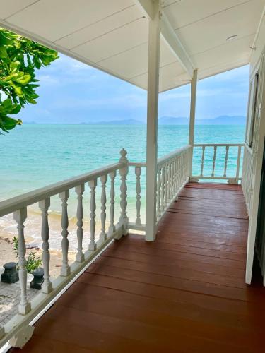 a porch with a view of the ocean at Peaceful Hideaway with Stunning View Beach Access in Mae Nam