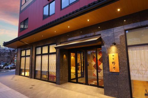a store front of a building with a sign on it at Natural Hot Spring Echizen no Yu Onyado Nono Fukui in Fukui
